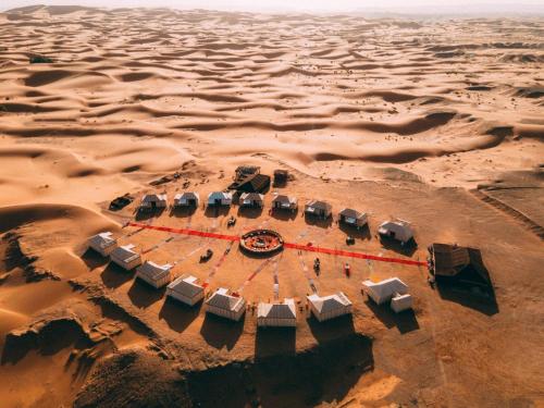 an aerial view of a desert with a group of tents at Riad Moha in Merzouga