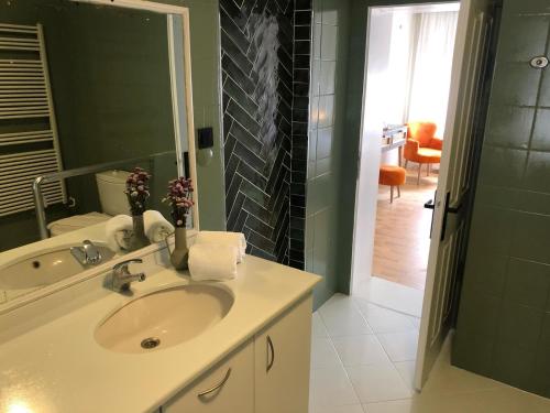 a bathroom with a sink and a mirror at Utopia Konak Otel in Bozuyuk