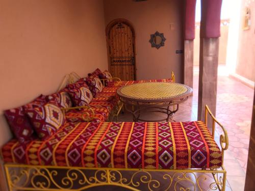 a living room with a couch and a table at Riad Moha in Merzouga