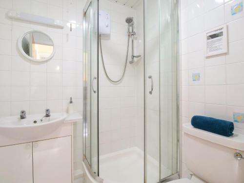 a bathroom with a shower and a sink at Kenegie Cottage in Penzance