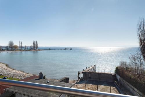a view of a body of water with a dock at Gästehaus D i c k r e i t e r in Immenstaad am Bodensee