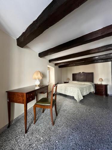 a bedroom with a bed and a desk and a desk at Antica Dimora in Catanzaro