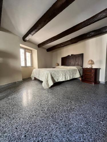 a bedroom with a large bed and a wooden dresser at Antica Dimora in Catanzaro