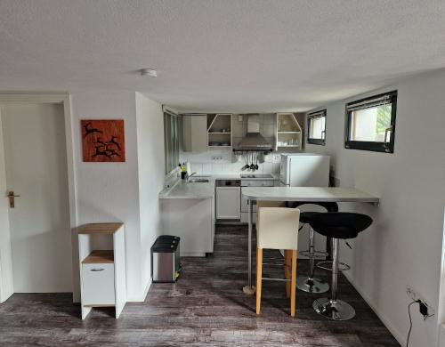 a kitchen with a table and chairs in a room at Dalea in Bad Waldsee