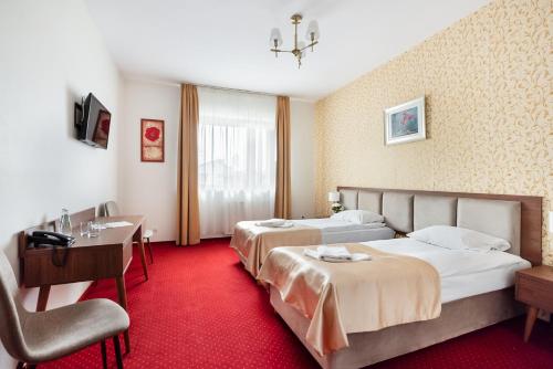 Posteľ alebo postele v izbe v ubytovaní Hotel Arkadia