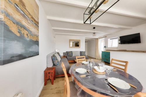 une salle à manger avec une table et un canapé dans l'établissement Petite Maison pour 4 dans le bourg de Sarzeau, à Sarzeau