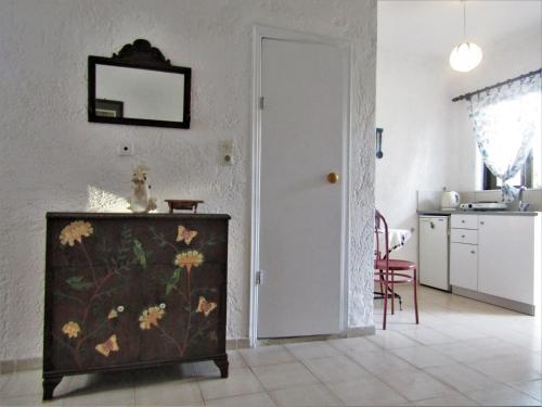 a living room with a dresser and a kitchen at Asklipion Valley guest house in Kos Town