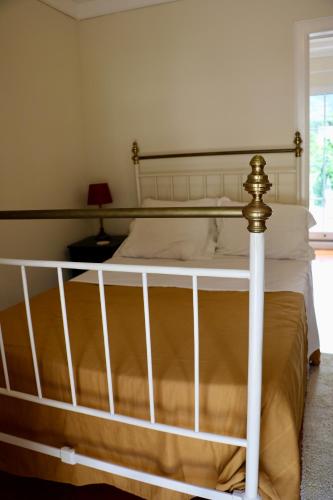 a bedroom with a bed with a white bed frame at Villa with Mountain view, São Vicente, Madeira in São Vicente