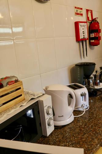 a kitchen counter with a microwave and a mixer at Villa with Mountain view, São Vicente, Madeira in São Vicente
