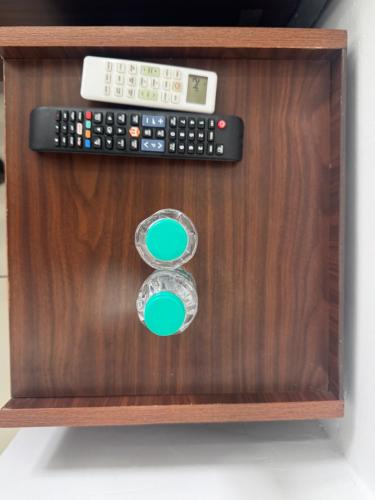 a remote control on top of a wooden cabinet at Feels Like Home in Ghaggar