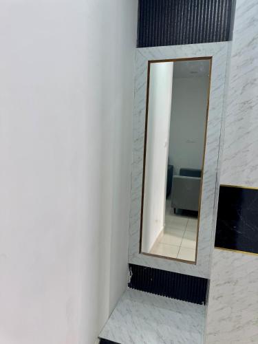 a mirror on a wall in a room at Feels Like Home in Ghaggar