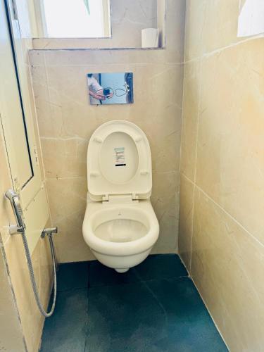 a bathroom with a toilet with the lid up at Feels Like Home in Ghaggar