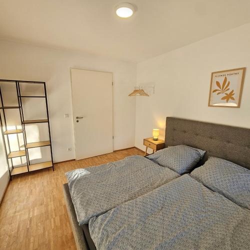 a bedroom with a bed and a door to a closet at Urban Suites HBN in Heilbronn