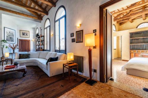 a living room with a couch and a bed at Palazzo Remer - luxury apartments - by Bricola Apartments in Venice