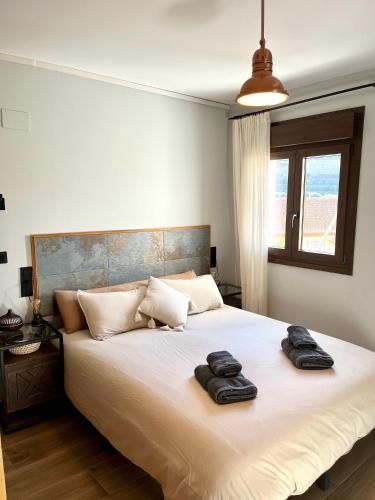 a bedroom with a large bed with two towels on it at La Boheme Casa Rural in Murchas