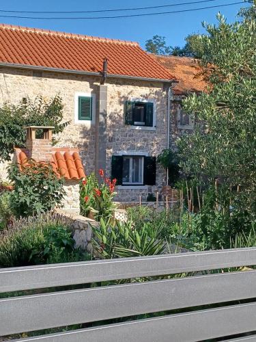 a stone house with a window on the side of it at Country house Koštela in Stankovci