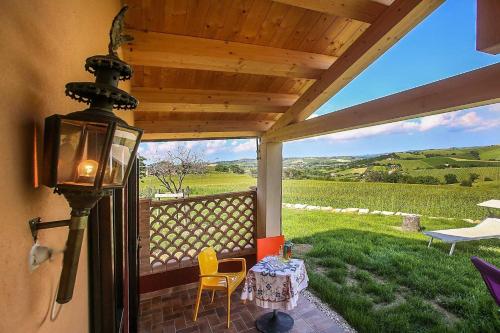 a screened in porch with a view of a field at Quindici Alberi La Chioccia in Serra deʼ Conti