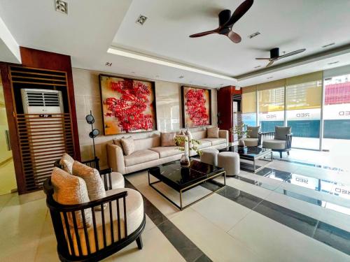 a living room with a couch and a table at Modern Makati Condo with Balcony & Cityscape Views in Manila