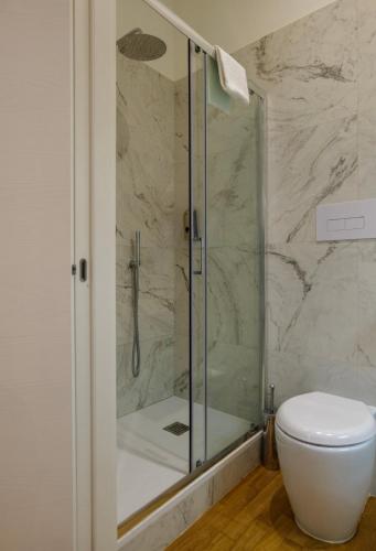 a bathroom with a glass shower with a toilet at Relais Vittorio Veneto - Luxotel & Apartotel in Salerno