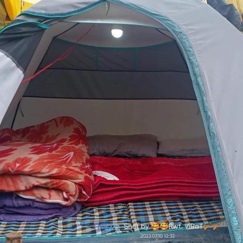 a bed in a tent with a red blanket at Shivalik Adventure By StayApart in Kedārnāth
