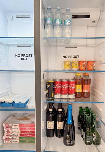 a refrigerator filled with lots of bottles of alcohol at Bed & Bergamo Casa Vacanze in Bergamo