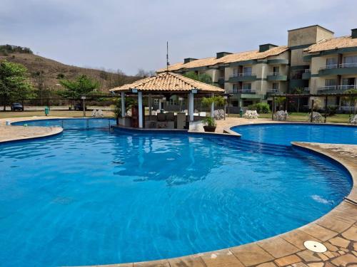 a large pool with a gazebo in a resort at Aldeia das Águas Village Park Flat A110 térreo in Barra do Piraí