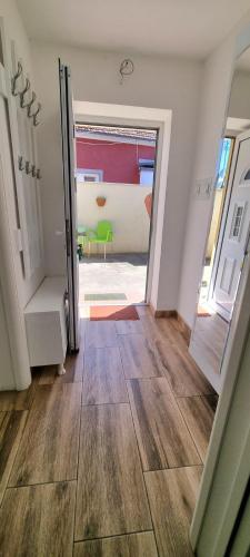 a hallway with a door open to a living room at "My Life" luxury river apartments in Niš