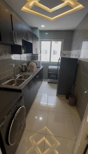 a kitchen with a sink and a dishwasher at Appartement 3 chambres in Conakry