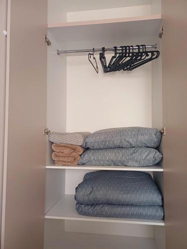 a group of towels on shelves in a closet at Your Home in Plovdiv with Free Private Parking in Plovdiv