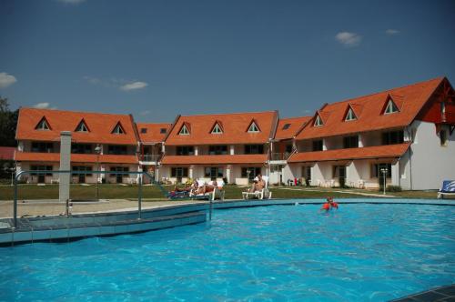 a large swimming pool in front of a building at Abbazia Country Club in Nemesnép