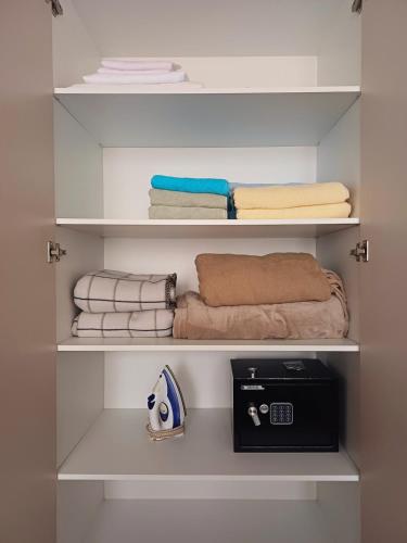 a walk in closet with towels and folded towels at Your Home in Plovdiv with Free Private Parking in Plovdiv