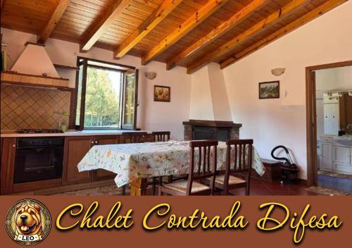 a kitchen and dining room with a table and chairs at Chalet Contrada Difesa in Bronte