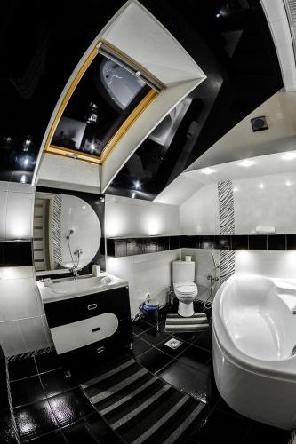 a bathroom with a sink and a toilet at Diamond De Luxe in Kolomyya
