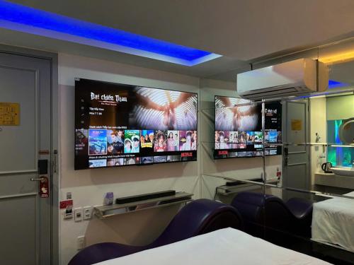 a hospital room with two monitors on the wall at Cupid Hotel in Ho Chi Minh City