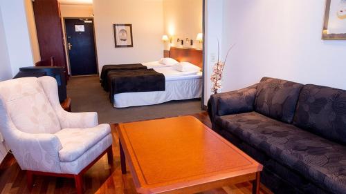 a living room with a couch and a bed at Ronneby Brunn in Ronneby