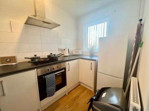 a small kitchen with a stove and a refrigerator at Stanley House in Stockton-on-Tees