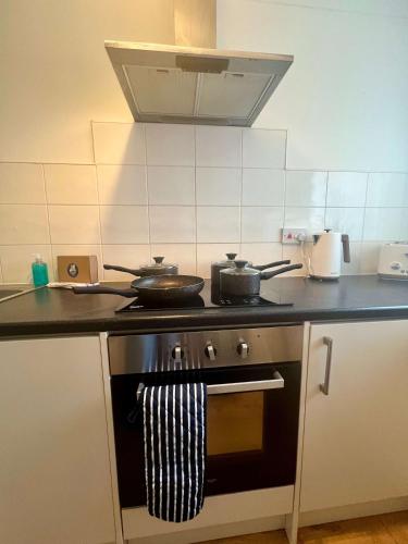 a kitchen with a stove with pots and pans on it at Stanley House in Stockton-on-Tees