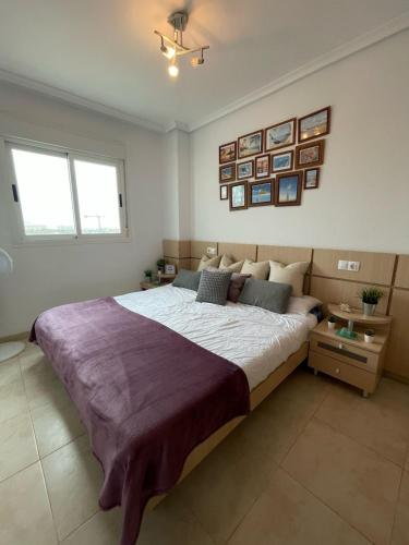 a bedroom with a large bed in a room at Apartamento 3 habitaciones en la playa de Magic World , Oropesa del Mar in Cabanes