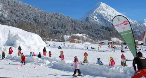 a group of people playing in the snow at SunAlpin - Ferienwohnungen in Schoppernau