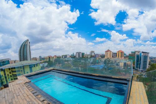 a swimming pool on top of a building with a city at The Lofts on Wood Avenue in Nairobi