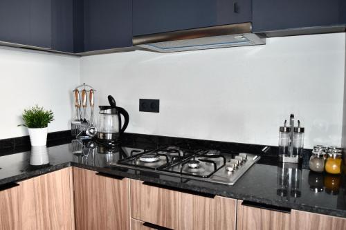 a kitchen with a stove and a counter top at Le Palmier - By Mi-Haven in Casablanca