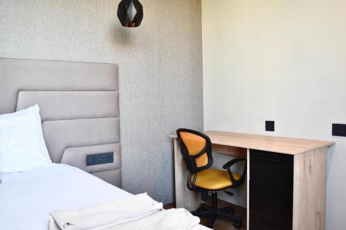 a bedroom with a desk and a bed and a desk and a chair at Le Palmier - By Mi-Haven in Casablanca