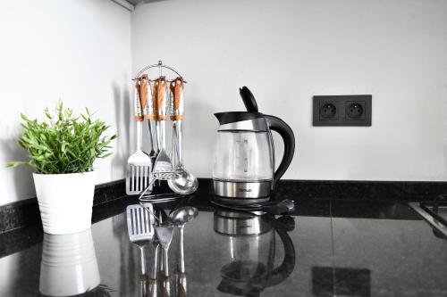 a blender on a counter with forks and spoons at Le Palmier - By Mi-Haven in Casablanca
