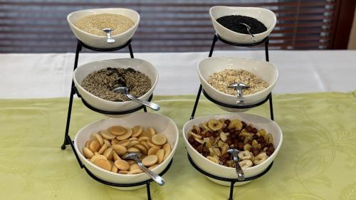 four bowls filled with different types of food on a table at Wellness Hotel Diplomat in Rajecké Teplice