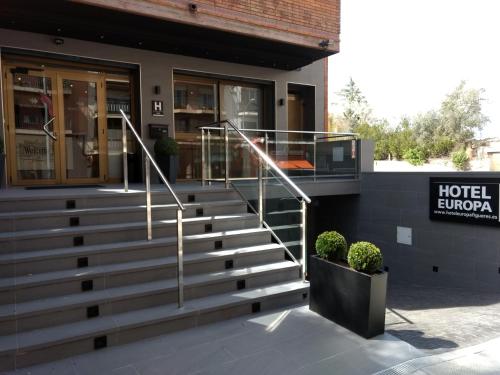a hotel lobby with stairs in front of a building at Hotel Europa in Figueres