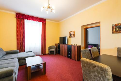 a living room with a couch and a table at Elzet penzion in Třeboň