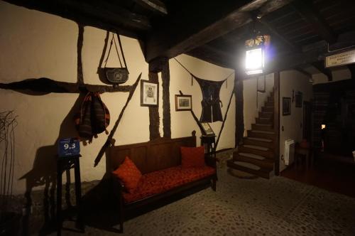 a living room with a couch and a stair case at Apartamentos Rurales Tía Josefa in Tornavacas