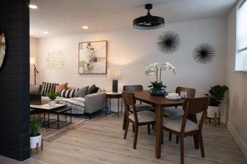 a living room with a table and a couch at Shares Loft Luxury Apt - NEW! in Rockledge