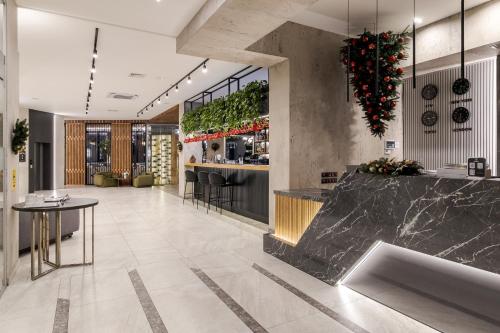 a lobby with a marble counter and a bar at Rest&Ski Spa Resort in Bukovel