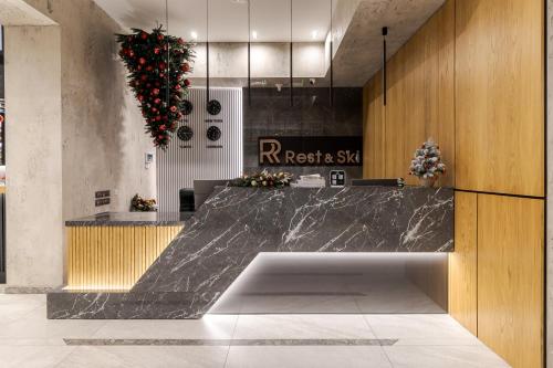 a lobby with a marble counter in a room at Rest&Ski Spa Resort in Bukovel